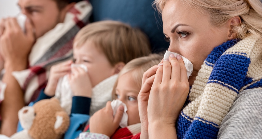 Close-up Shot Of Sick Young Family Blowing Noses With Napkins To