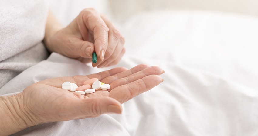 Senior Woman Holding Pills In Hand, Taking Medication From Palm,